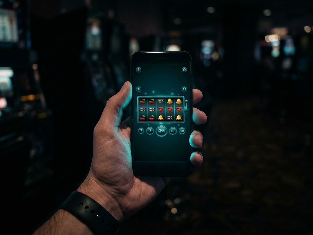 Smartphone showing casino game with teal screen glow